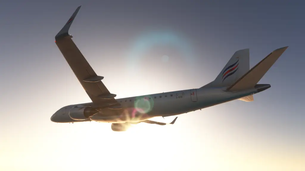 An Embraer E190 E-Jet captured in flight against a clear sky with a beautiful sunset glow illuminating the aircraft from behind.